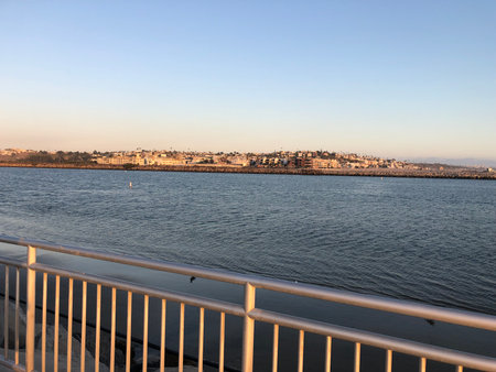 Calm Evening by the Waterfront Showcasing a Serene Landscape With Distant City Viewsの写真素材