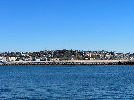 Calm Waters Reflect the Beauty of Coastal Homes on a Bright Sunny Day at the Harborの写真素材