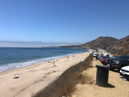 Sunny Beach Day at a California Coastline With Waves and Distant Hills in Summerの写真素材