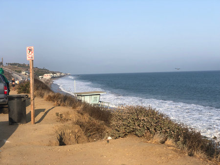 Coastal Views Capture the Serenity of Waves Crashing Against the Shore During a Calm Afternoonの写真素材