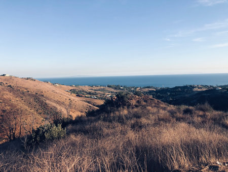 Expansive Ocean View From a Hillside Overlooking a Tranquil Coastal Landscapeの写真素材