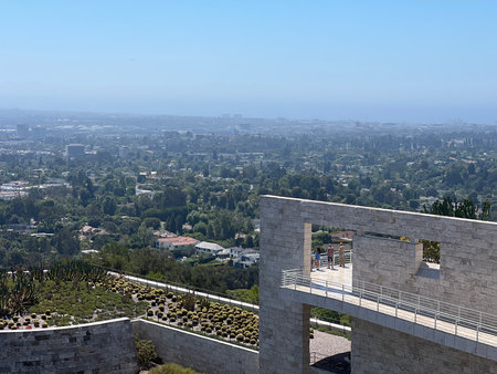 Scenic View Overlooking a Lush Green Landscape and City Skyline From an Outdoor Terrace on a Sunny Dayの写真素材