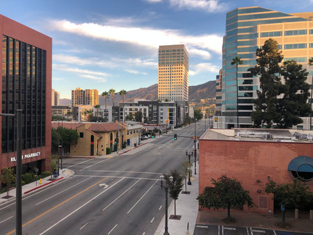 Downtown City View Captures Modern Architecture Set Against a Beautiful Mountain Landscape During Early Morning Lightの写真素材