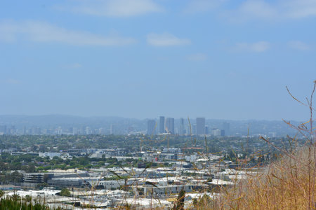 Views of the Sprawling Cityscape Under a Clear Blue Sky With Distant Hills in the Backgroundの写真素材
