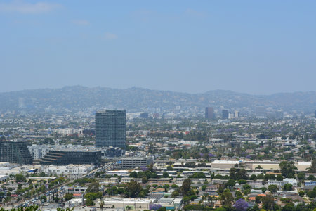 Vibrant Cityscape of Los Angeles Showcasing Urban Life and Distant Mountains During a Sunny Dayの写真素材