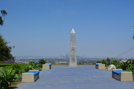 Scenic View From Griffith Park With an Obelisk and a Panoramic City Skyline Under a Clear Blue Skyの写真素材