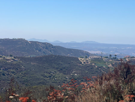 Expansive Mountain View Reveals Distant Hills and Lush Green Valleys During Bright Midday Lightの写真素材
