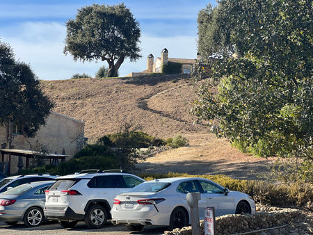 Exploring the Hillside Landscape Near Historic Buildings Basked in Afternoon Sunlightの写真素材