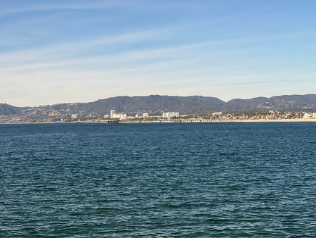 Vibrant Coastal View of a Bustling Seaside City Under a Clear Blue Skyの写真素材