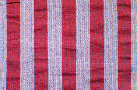 Stripes of red, white, grey colors on fabricの写真素材