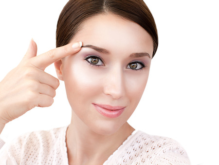 Womans face with dewy skin make up isolated on whiteの写真素材