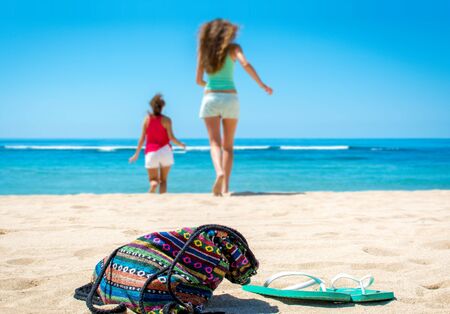 Two happy women running to the oceanの写真素材