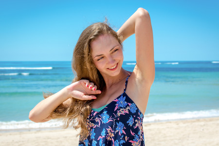 Young attractive woman enjoing the sunlight at the beachの写真素材