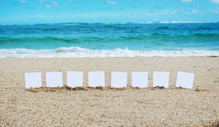 Message with a place for your text on the beach. Empty cards for letters on the sand.