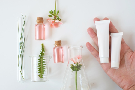 package with laboratory experiment and research with leaf, oil and ingredient  extract for natural beauty  and organic skincare product package,bio science concept. alternative medicine. spaの写真素材