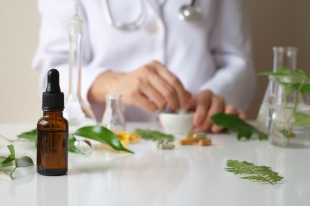 alternative medicine herb , mortar, laboratory glassware, plant in tube, flower , on white background.の写真素材