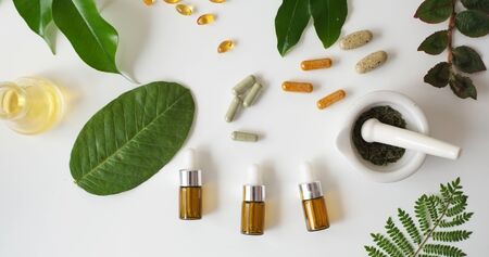 alternative medicine herb , mortar, laboratory glassware, plant in tube, flower , on white background.の写真素材