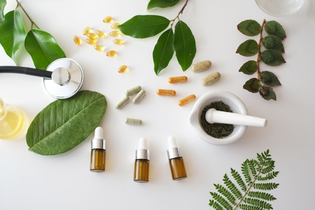 alternative medicine herb , mortar, laboratory glassware, plant in tube, flower , on white background.の写真素材