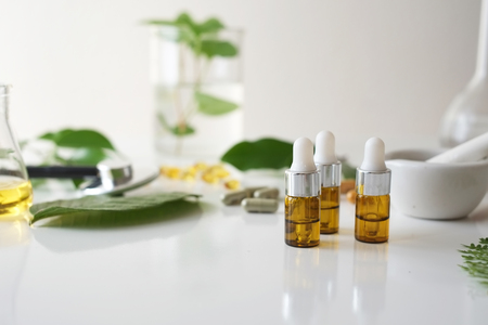alternative medicine herb , mortar, laboratory glassware, plant in tube, flower , on white background.の写真素材