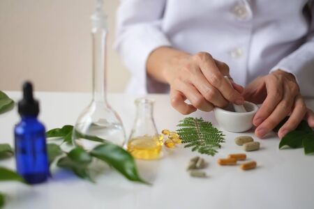 alternative medicine herb , mortar, laboratory glassware, plant in tube, flower , on white background.の写真素材
