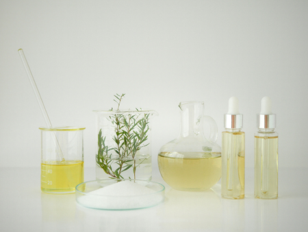 natural cosmetic skincare serum packaging with leaf, home made oil and beauty vitamin...