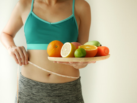 slim woman wear active with beautiful body waist after diet food, weight loss concept and healthy lifestyle.isolated on white with copy space.の写真素材