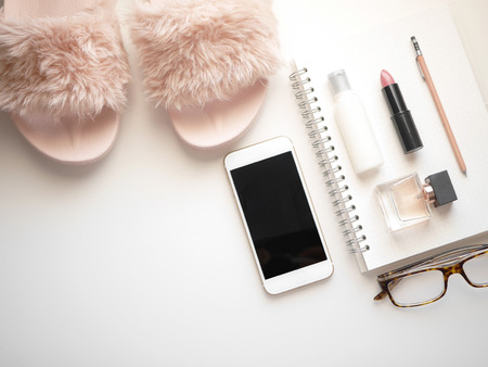 Flat lay woman accessories  white background with cosmetic ,notebook, pen and mobile phone. isolated.の写真素材