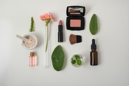 Cosmetic package containers with green leaves, pink salt,herbal . natural  organic beauty product concept mock up. Blank bottle for label own branding skincare. isolated white background.top view.の写真素材