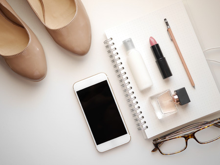 Flat lay woman accessories  white background with cosmetic ,notebook, pen and mobile phone. isolated.の写真素材
