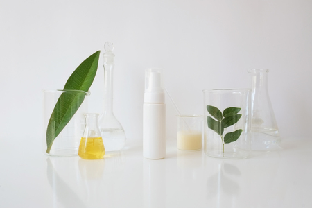 skincare and cosmetic package with laboratory glassware and leaf  for natural beauty and organic skincare on white background.の写真素材