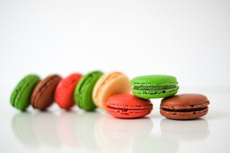 Colorful macaroons or macaron on a white wooden background.Isolated. French delicious pastry.の写真素材
