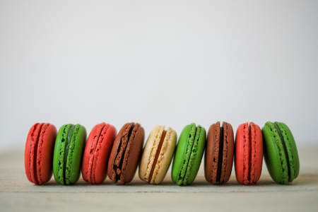 Colorful macaroons or macaron on a white wooden background.Isolated. French delicious pastry.の写真素材
