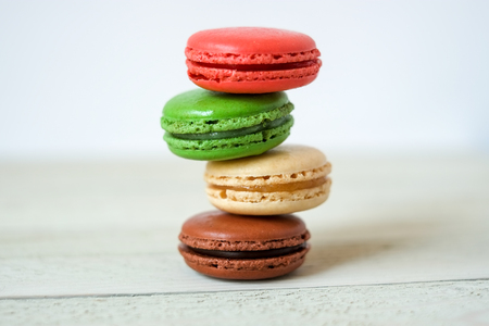 Colorful macaroons or macaron on a white wooden background.Isolated. French delicious pastry.の写真素材