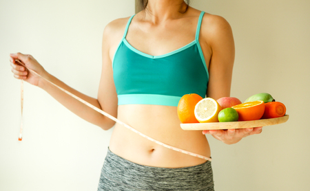 slim woman wear active with beautiful body waist after diet food, weight loss concept and healthy lifestyle.isolated on white with copy space.の写真素材