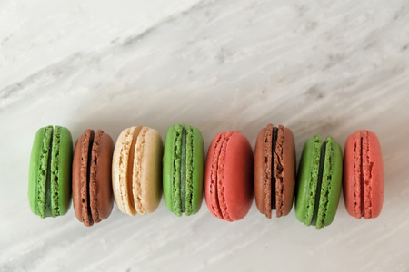 Colorful macaroons or macaron on a white wooden background.Isolated. French delicious pastry.の写真素材