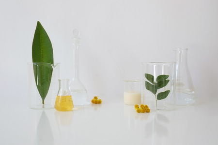 laboratory equipment for alternative medicine, science experiments, formulating organic skincare, herbal medicine and natural remedy pharmaceutical. white backgroundの写真素材