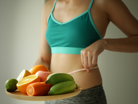 slim woman wear active with beautiful body waist after diet food, weight loss concept and healthy lifestyle.isolated on white with copy space.の写真素材