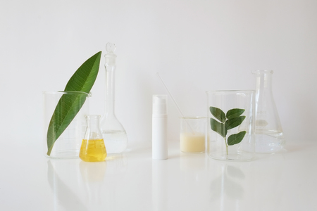 skincare and cosmetic package with laboratory glassware and leaf  for natural beauty and organic skincare on white background.の写真素材