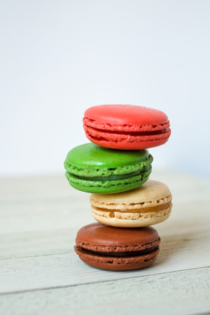 Colorful macaroons or macaron on a white wooden background.Isolated. French delicious pastry.の写真素材
