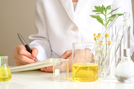 the scientist or doctor make herbal medicine from herb in the laboratory on the table .alternative treatment. show hand and stethoscope. with the bottle container.の写真素材