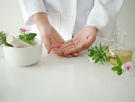 the scientist,dermatologist testing the organic natural cosmetic product in the laboratory.research and development beauty skincare concept.blank package,bottle,container .cream,serum.handの写真素材