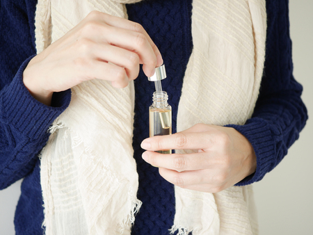 young woman apply natural oil, cosmetic,skin care regimen for winter moisturizer.