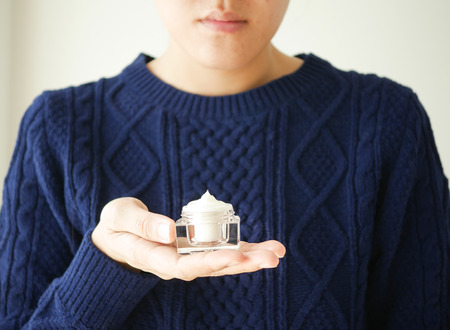 young woman applying cream,moisturizer, cosmetic,skin care regimen.skincare step.の写真素材
