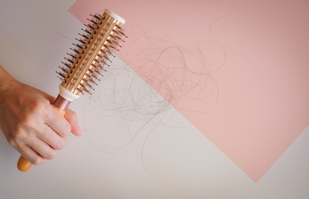 hair fall and lost alopecia woman problem on the comb.の写真素材