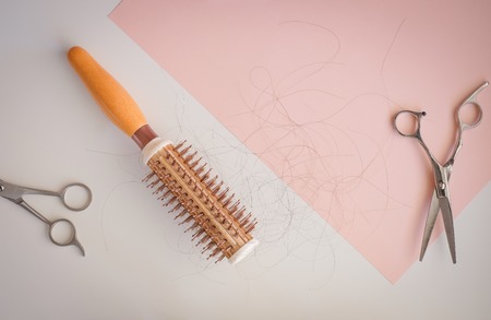 hair fall and lost alopecia woman problem on the comb.