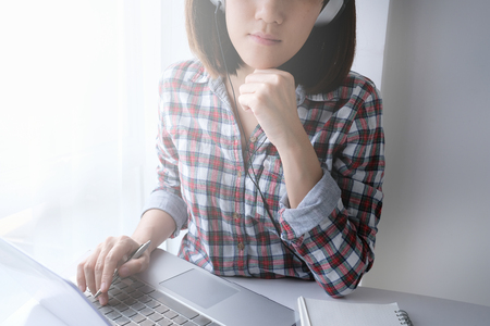 young asian woman work and e learning . online working business in office. blog.の写真素材
