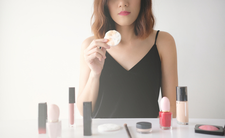 Young beautiful woman applying make up.の写真素材