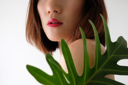 Young beautiful woman applying make up.の写真素材