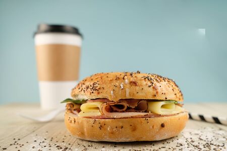 Delicious classic blt sandwiches with ham, cheese, bacon, tomatoes. Breakfast and fast food meal. on isolated light blue background wooden and text copy space.の写真素材