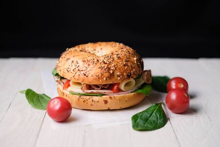 Delicious classic blt sandwiches with ham, cheese, bacon, tomatoes. Breakfast and fast food meal. on isolated black background wooden and text copy space.の写真素材